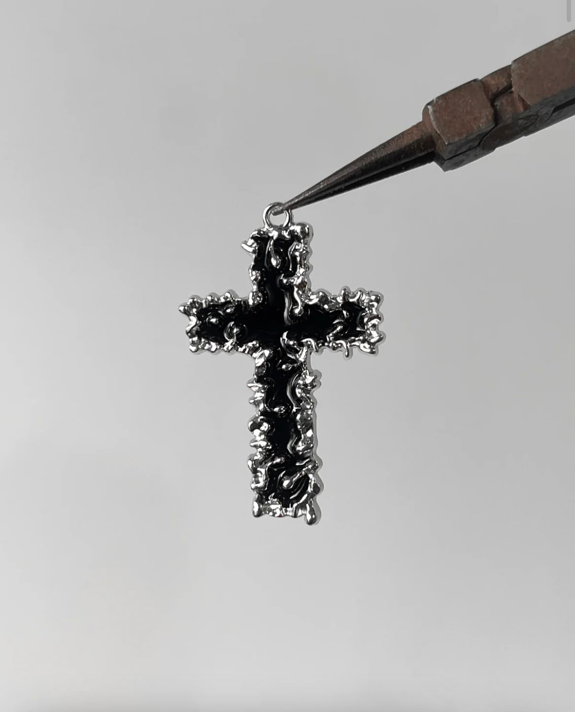 Melting cross charm